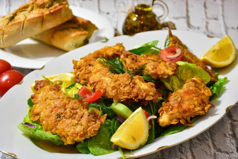 Air-fried frozen chicken tenders arranged on a plate with dipping sauce, golden and crispy