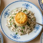 Classic Southern Creamed Chicken and Biscuits served on a rustic plate