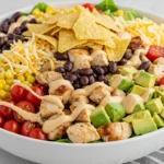 Bowl of southwest chopped chicken salad with avocado, beans, and creamy dressing