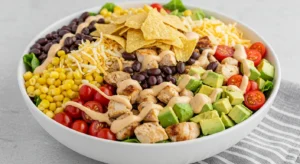 Bowl of southwest chopped chicken salad with avocado, beans, and creamy dressing
