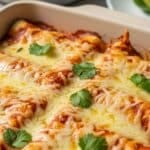 Baked chicken enchilada recipe with melted cheese and cilantro