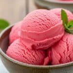 Watermelon sorbet served in a ceramic bowl with mint