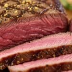 Perfectly cooked sous vide tri tip sliced medium rare on a cutting board