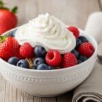 Fresh berries and cream dessert in a bowl