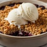 Fresh-baked blackberry crisp with oat topping and vanilla ice cream