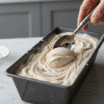 Frozen vegan ice cream being scooped from pan