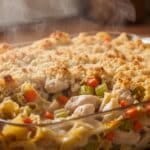 Chicken noodle casserole in baking dish with golden topping.