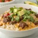 creamy queso steak rice bowl featured image
