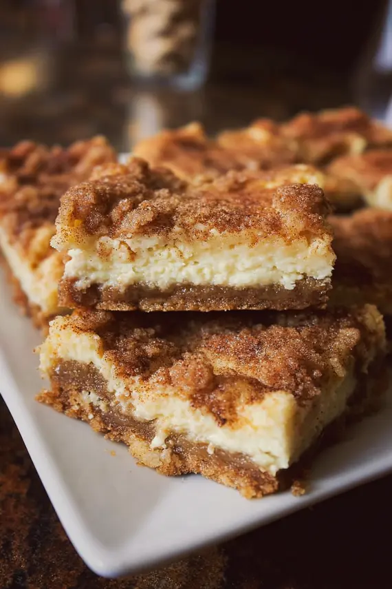 Freshly baked fantastic snickerdoodle cheesecake bars with cinnamon sugar topping