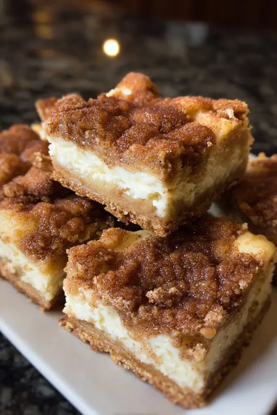 Fantastic snickerdoodle cheesecake bars served with whipped cream and cinnamon garnish