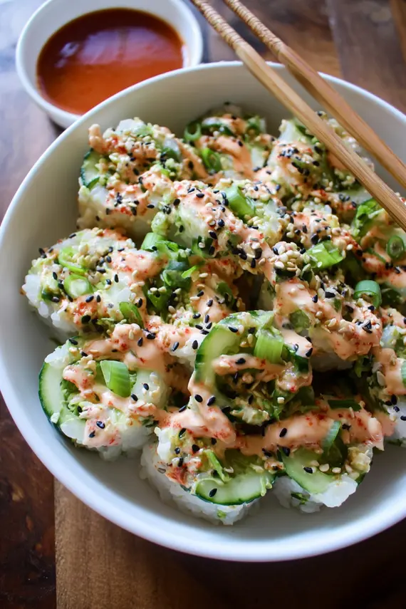 California Roll Cucumber Salad in a white bowl garnished with sesame seeds and nori strips