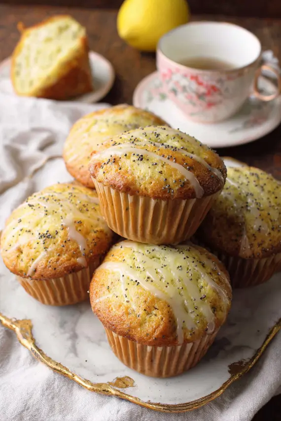 Freshly baked lemon poppy seed muffins on a cooling rack