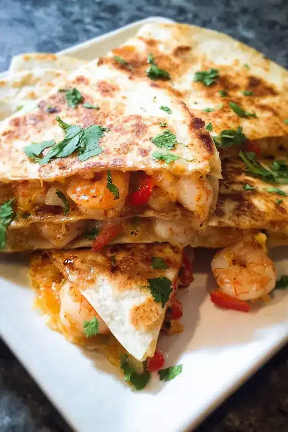 Easy shrimp quesadilla served with fresh salsa, guacamole and lime wedges