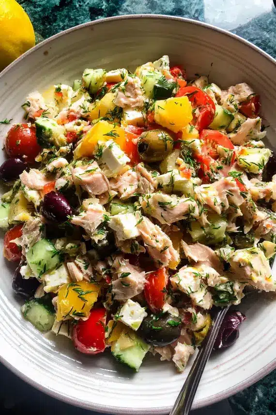 Freshly prepared Mediterranean tuna salad in a white bowl garnished with parsley