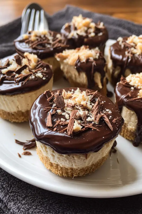 No bake mini peanut butter cheesecakes with chocolate drizzle on a serving tray