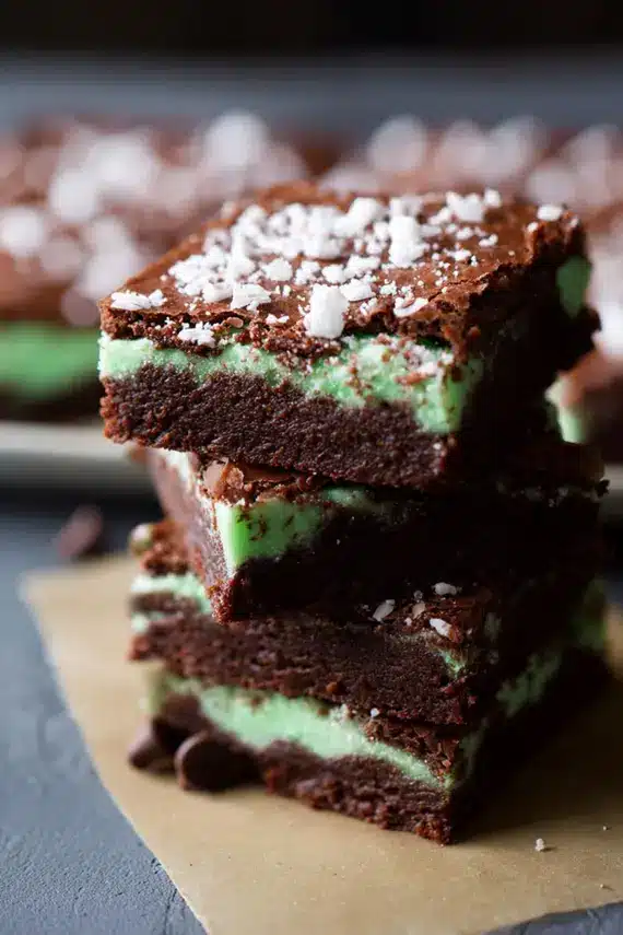 Close-up of a perfect slice of copycat BYU mint brownie showing the distinct chocolate base, vibrant green mint layer, and glossy chocolate ganache top