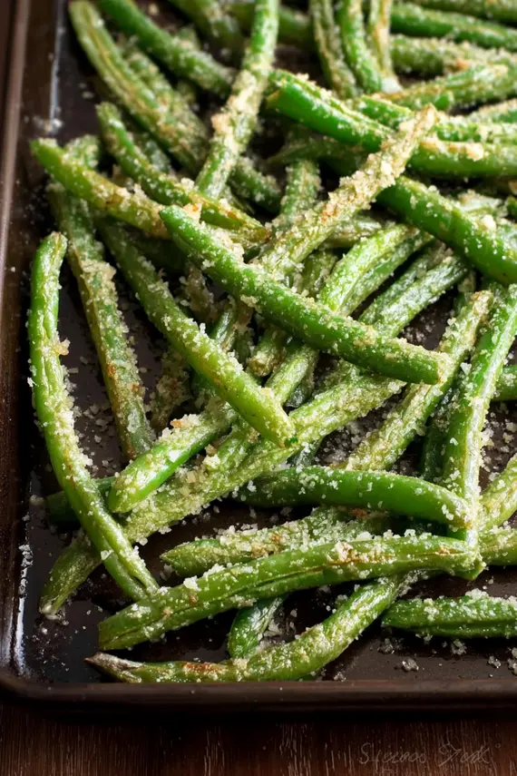 Parmesan roasted green beans served in a white bowl as a side dish
