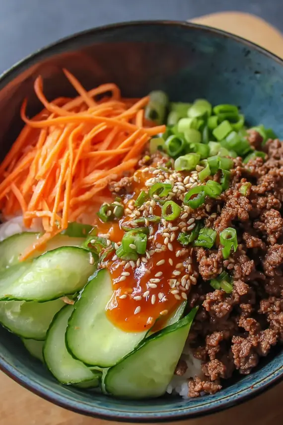 Korean beef bowl with colorful toppings arranged in a beautiful pattern