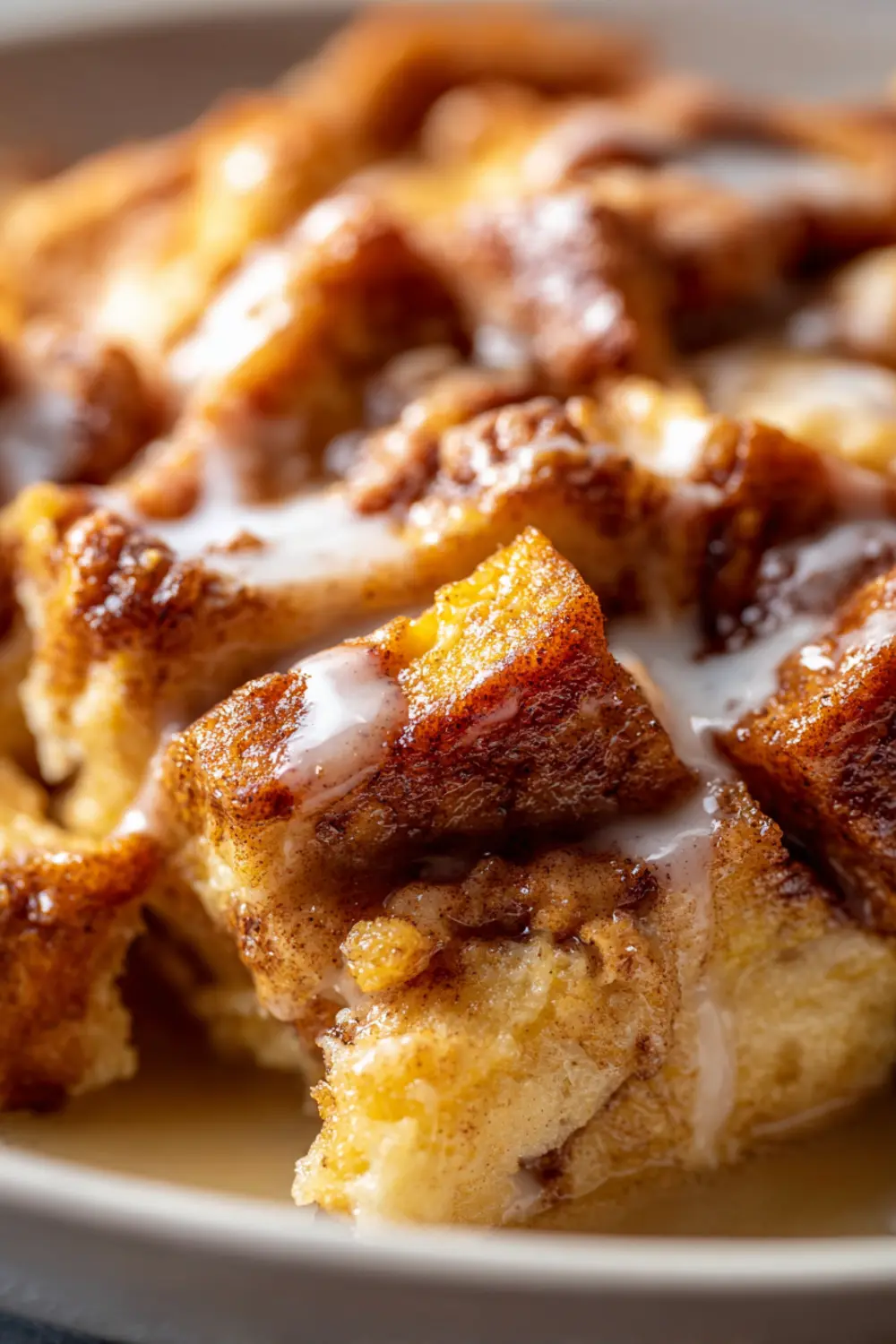 Sweet cinnamon roll bake in a baking dish showing golden brown top and cinnamon swirls