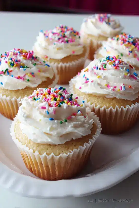 Beautifully arranged birthday vanilla cupcakes on a decorative stand