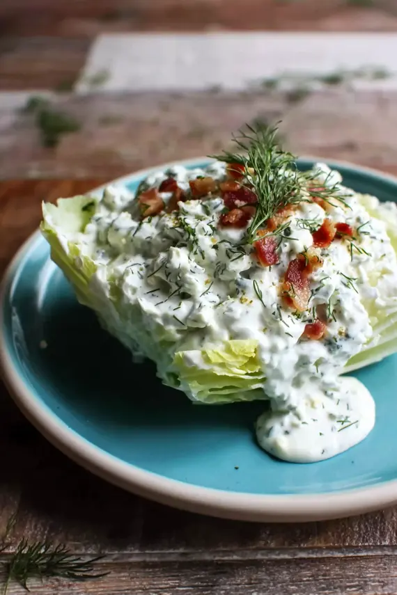 Creamy wedge salad dip in a bowl surrounded by fresh vegetables