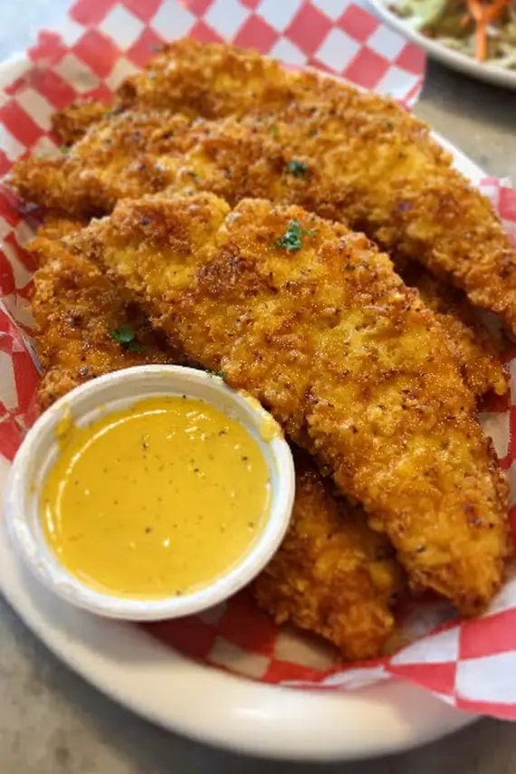 Crispy air fryer chicken tenders arranged on a serving plate