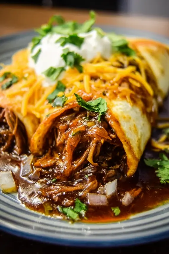 Freshly prepared BBQ beef burritos showing the tender shredded beef filling with melted cheese