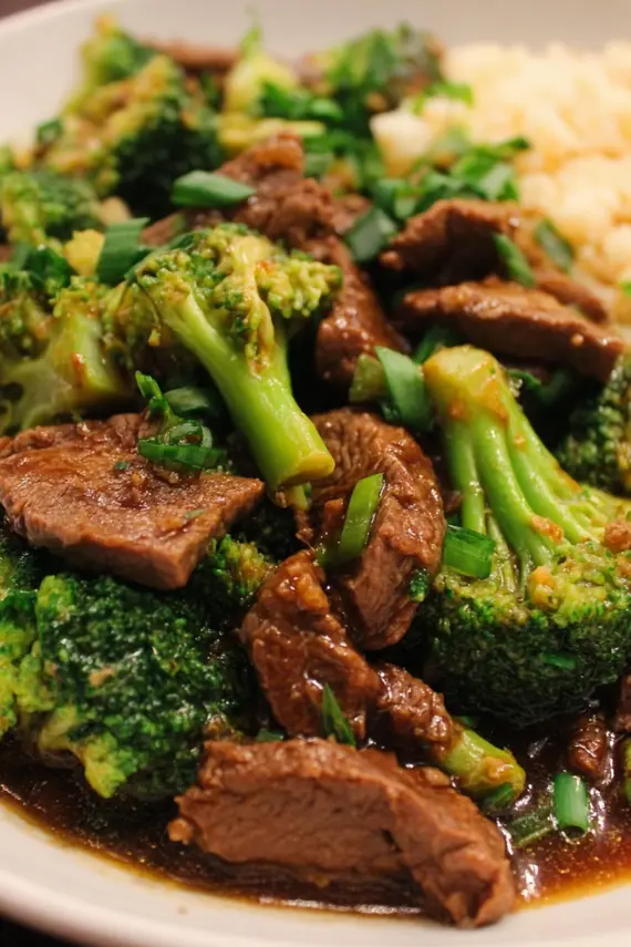 Delicious instant pot beef broccoli in a bowl showing tender beef strips and bright green broccoli in glossy sauce