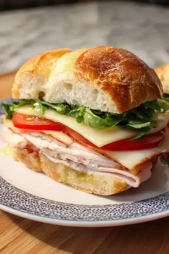 Close-up of creamy brie cheese melting slightly on a Turkey Brie Ciabatta Sandwich