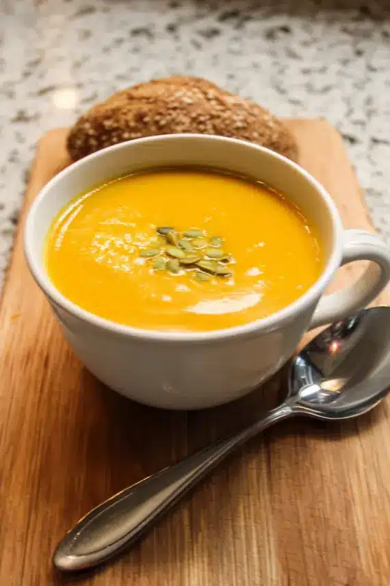 Plant based vegan butternut squash soup with various toppings and serving ideas