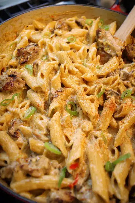 Caribbean pasta bake served with lime wedges and fresh herbs