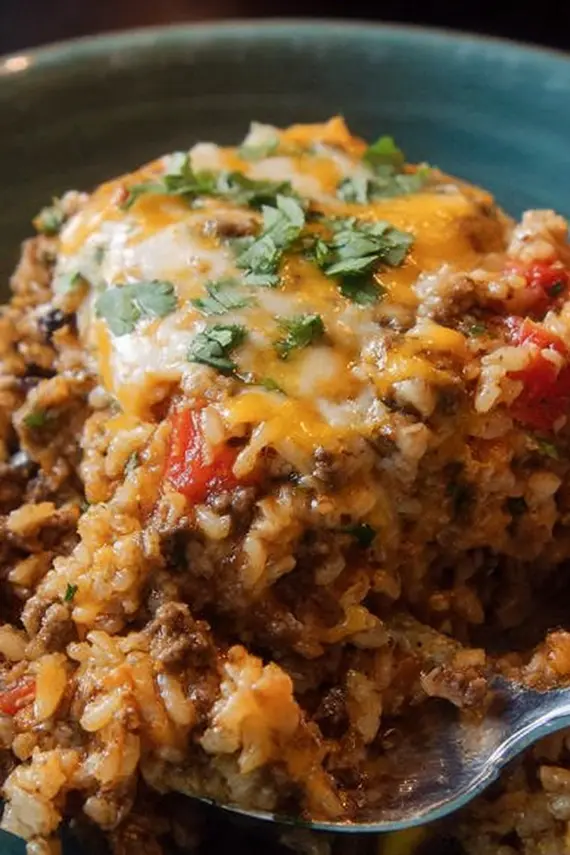 Cheesy rice casserole served with toppings and side dishes