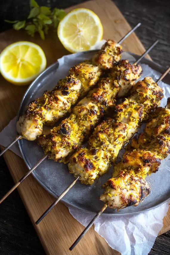 Plated Lemon Tahini Chicken Kebabs with colorful vegetables and garnishes