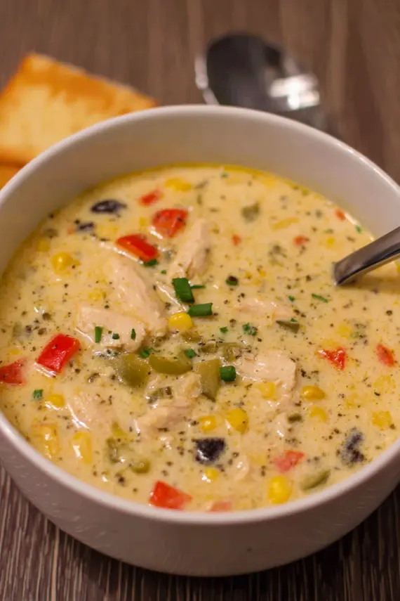 Creamy Chicken Pepper Soup in a white bowl with fresh herbs as garnish