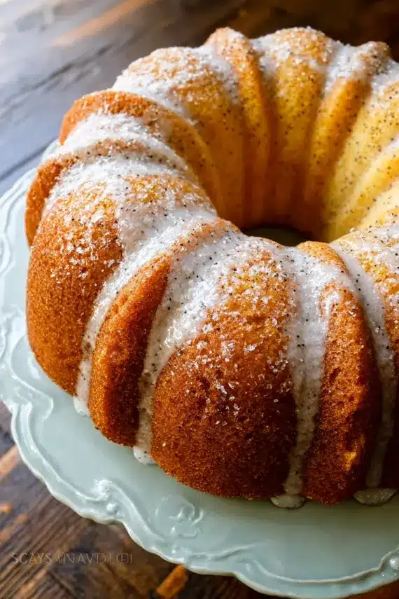 Cinnamon lemon poppy seed bundt cake with glaze dripping down the sides