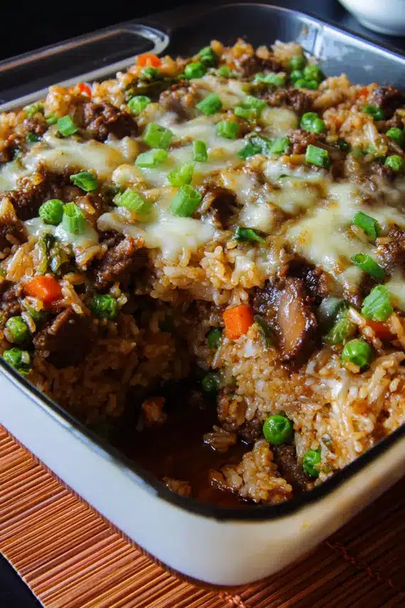 Teriyaki beef casserole being served with steamed vegetables and chopsticks