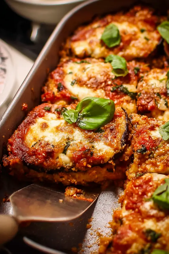 Freshly baked Eggplant Parmesan with melted cheese and herbs
