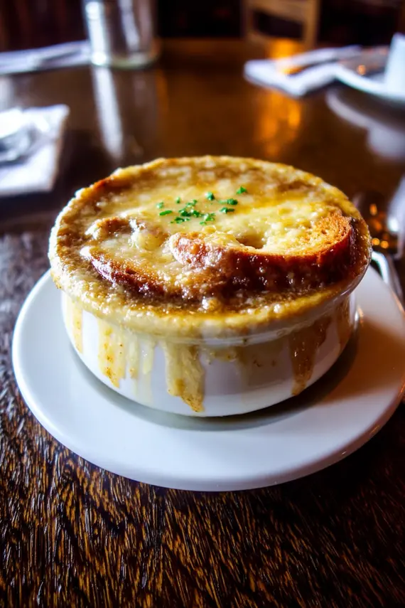 French onion soup with melted cheese and toasted bread in a ceramic bowl