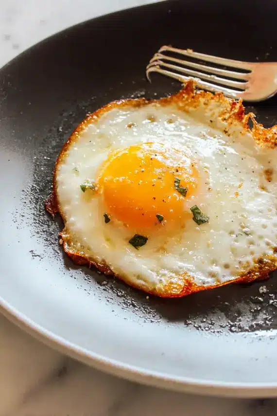 Perfectly cooked fried egg with golden edges and runny yolk