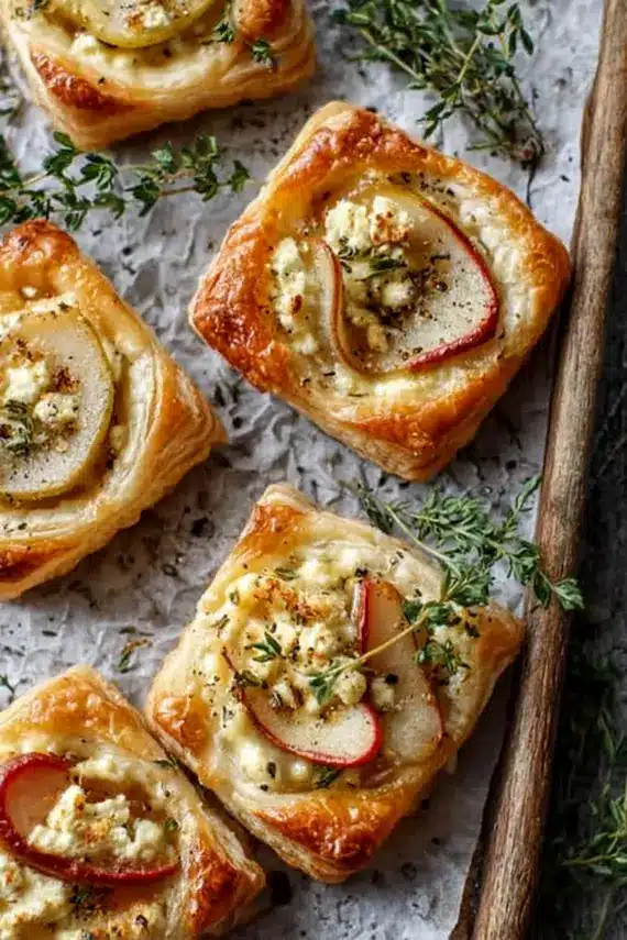 Close-up of pear goat cheese puff pastry tart showing flaky layers and golden crust