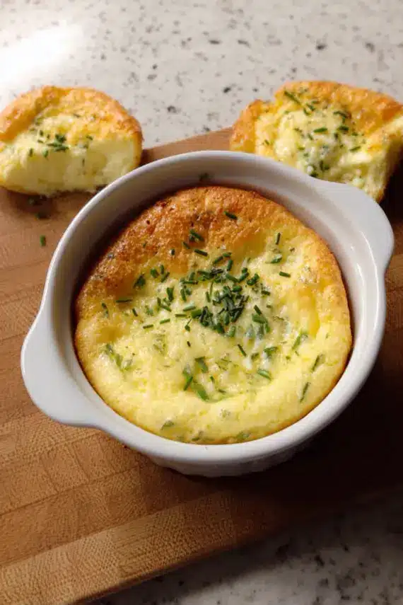 Perfectly risen goat cheese soufflé with a golden top and fluffy interior