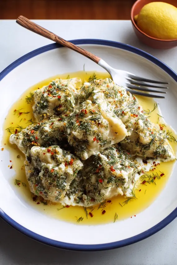 Greek feta dumplings with dill sauce on a white plate