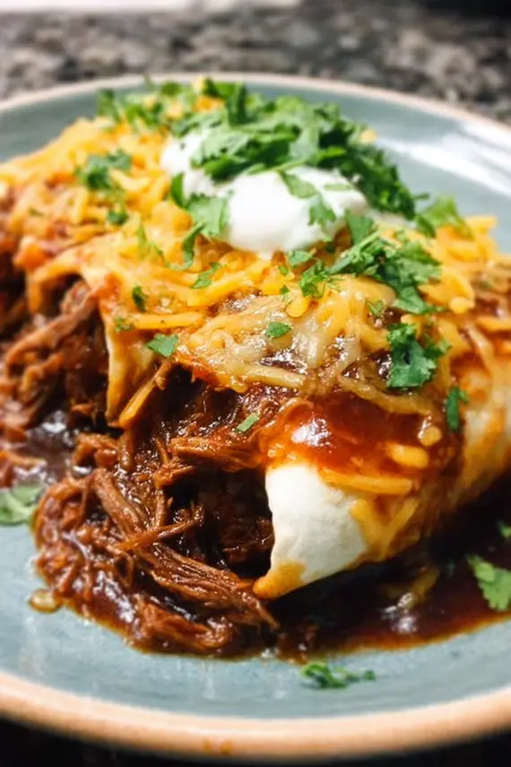 A complete meal featuring BBQ beef burritos served with side dishes and garnishes