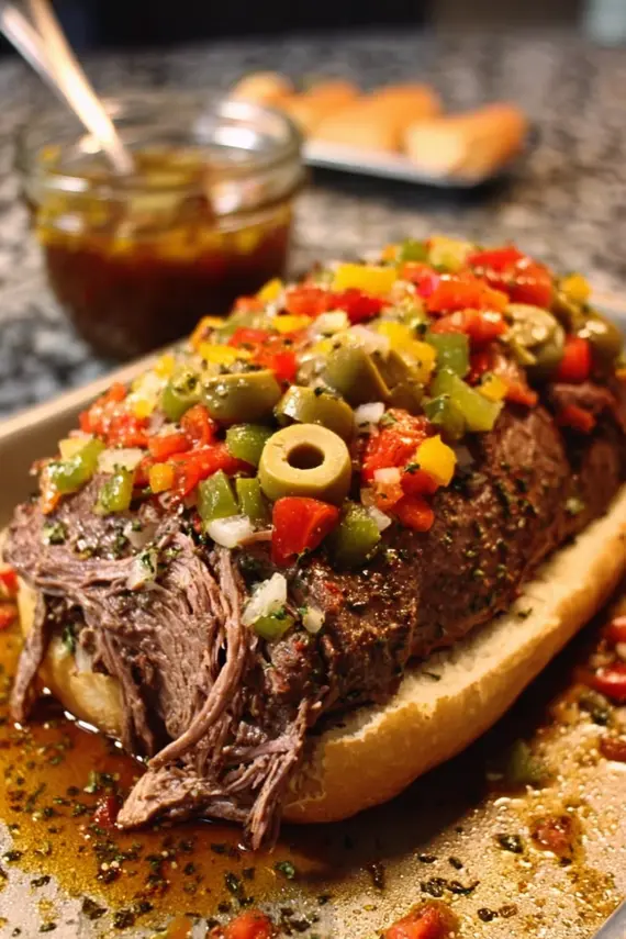 Sliced Italian Giardiniera Beef Roast served with vegetables and herbs on a platter