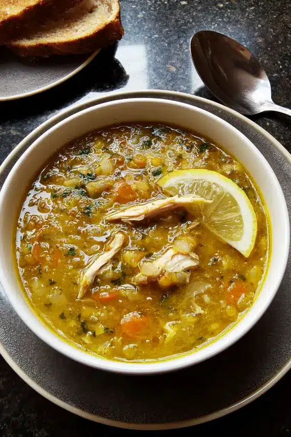 Close-up of lemon chicken broth with herbs