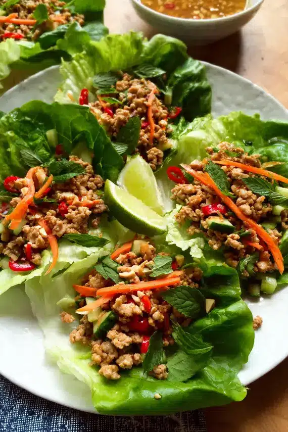 Thai Chicken Lettuce Wraps with fresh vegetables and herbs