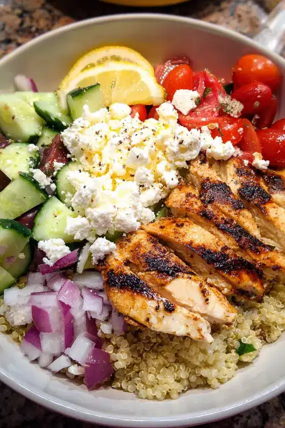 Mediterranean quinoa salad with fresh vegetables, olives and herbs