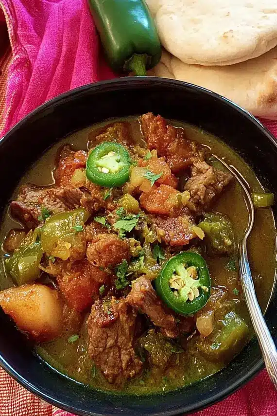 Mexican Green Chile Beef Stew served with various sides and toppings