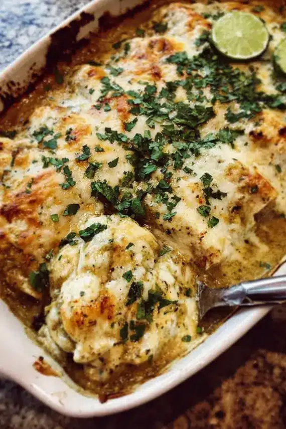 Finished roasted tomatillo chicken enchiladas with garnishes