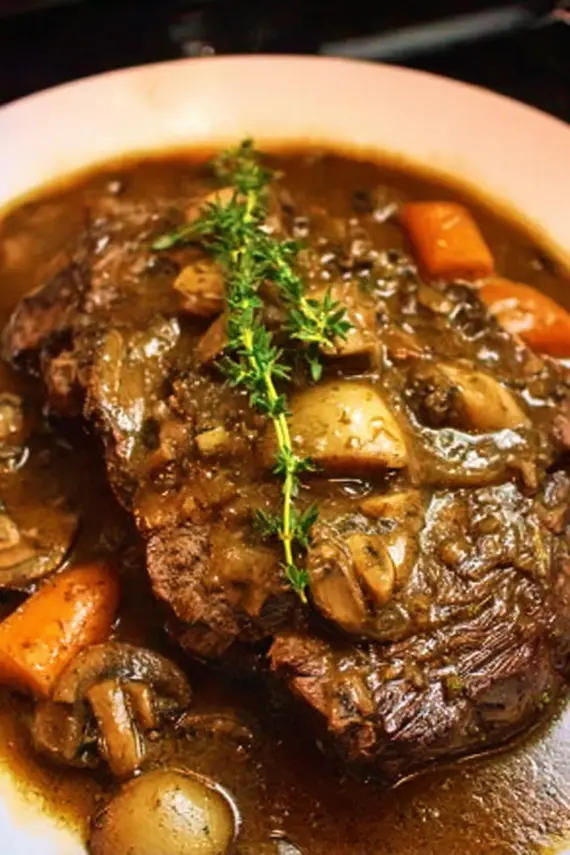 Close up of mushroom gravy being poured over beef roast